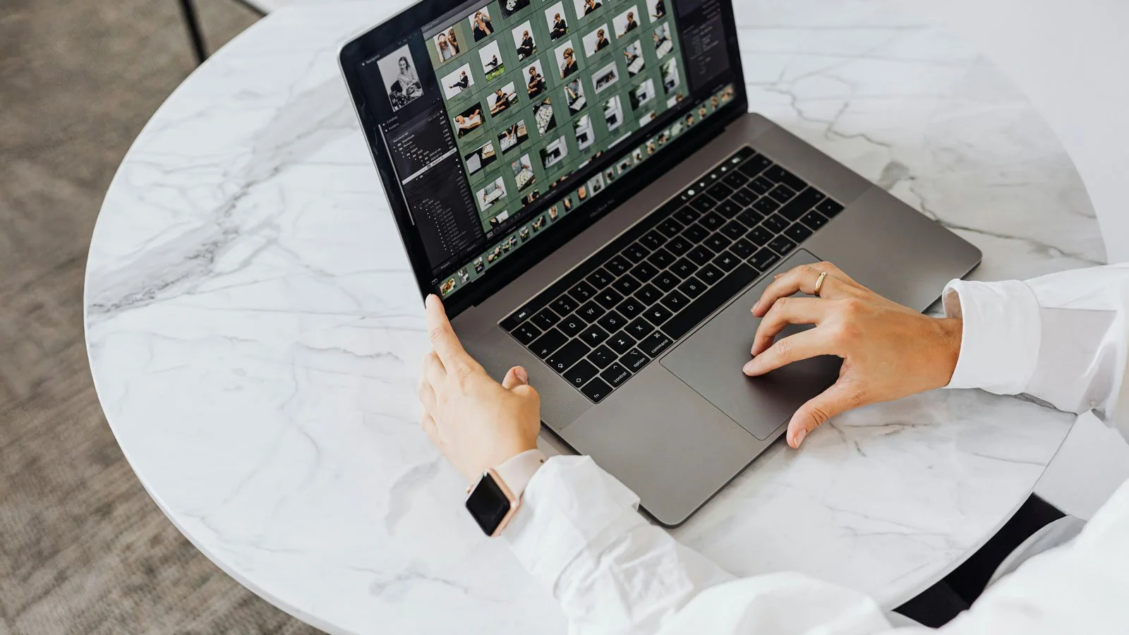 Man in white shirt using a MacBook Pro for Photo Editing