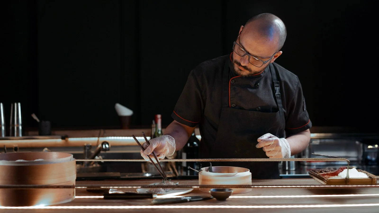 Man Wearing an Apron Preparing Food at the Counter